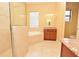 Bright bathroom featuring granite countertops, shower, bathtub and a glass block window at 6408 Christina Chase Pl, Lakeland, FL 33813