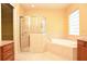 Bathroom featuring granite countertops, shower, bathtub and a glass block window at 6408 Christina Chase Pl, Lakeland, FL 33813