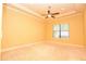 Empty bedroom featuring plush carpet, a ceiling fan, and natural light streaming through a window at 6408 Christina Chase Pl, Lakeland, FL 33813