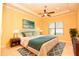 Serene bedroom with a trey ceiling, ceiling fan, and large windows for ample natural light at 6408 Christina Chase Pl, Lakeland, FL 33813