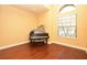 Music room featuring a piano, hardwood floors, large window with natural light, suitable for hobbyists at 6408 Christina Chase Pl, Lakeland, FL 33813