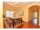 Elegant dining room with a table set for six, beautiful painting, and a view to the front entryway at 6408 Christina Chase Pl, Lakeland, FL 33813