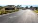 View of the Christina Chase community entrance with gated access and manicured landscaping along the road at 6408 Christina Chase Pl, Lakeland, FL 33813
