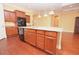 The kitchen features natural-wood cabinets and a granite island with black appliances and a chrome faucet at 6408 Christina Chase Pl, Lakeland, FL 33813