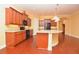 The kitchen shows natural-wood cabinets, granite countertops, and sleek black appliances at 6408 Christina Chase Pl, Lakeland, FL 33813