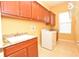 Well-equipped laundry room with sink, washer, dryer and ample storage space at 6408 Christina Chase Pl, Lakeland, FL 33813