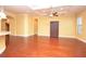Spacious living room boasts tray ceilings, recessed lighting, archways, and gleaming wood floors at 6408 Christina Chase Pl, Lakeland, FL 33813