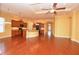 Open-concept living space with wood floors, granite countertops, and a seamless flow for entertaining at 6408 Christina Chase Pl, Lakeland, FL 33813