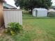 Backyard featuring two storage sheds and ample green space, perfect for storage and outdoor activities at 7923 Glenridge E Loop, Lakeland, FL 33809