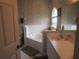 Well-lit bathroom with a soaking tub, toilet, and a single vanity sink at 7923 Glenridge E Loop, Lakeland, FL 33809