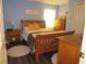 Cozy bedroom with natural wood furniture, a neutral rug, and blue walls at 7923 Glenridge E Loop, Lakeland, FL 33809