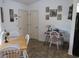 Bright dining area featuring a table with four chairs, adjacent to a workspace with a desk and chair at 7923 Glenridge E Loop, Lakeland, FL 33809