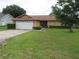 Charming single-story home with a well-manicured lawn and mature tree offering curb appeal at 7923 Glenridge E Loop, Lakeland, FL 33809
