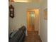Hallway view leading to the bathroom with tile flooring and neutral paint scheme at 7923 Glenridge E Loop, Lakeland, FL 33809