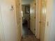 Hallway that leads to the living room and bedrooms, tile flooring and neutral paint scheme at 7923 Glenridge E Loop, Lakeland, FL 33809