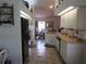 Bright kitchen with modern appliances, tile floors, and views into the dining area at 7923 Glenridge E Loop, Lakeland, FL 33809