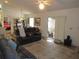 Open living area with sliding doors to a screened porch and modern furniture at 7923 Glenridge E Loop, Lakeland, FL 33809