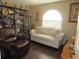 The living room has hardwood floors, is decorated with an area rug and has plenty of natural light at 7923 Glenridge E Loop, Lakeland, FL 33809