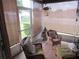 Screened porch with outdoor seating and view of the backyard at 7923 Glenridge E Loop, Lakeland, FL 33809