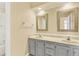 Bathroom featuring dual sinks, framed mirrors, and a bathtub at 351 Crystal Ridge Way, Lake Mary, FL 32746