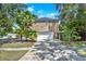 Brick two-story home featuring a two-car garage, driveway, and tropical landscaping at 351 Crystal Ridge Way, Lake Mary, FL 32746