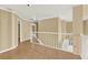 Bright upstairs hallway with wood floors, white railings, and views to the floor below at 351 Crystal Ridge Way, Lake Mary, FL 32746