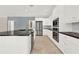 Modern kitchen featuring white cabinetry, black countertops, and stainless steel appliances at 351 Crystal Ridge Way, Lake Mary, FL 32746