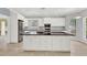 Bright kitchen featuring white cabinets, black countertops, and a large central island with sink at 351 Crystal Ridge Way, Lake Mary, FL 32746