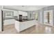 Bright kitchen featuring white cabinets, black countertops, and a large central island with sink at 351 Crystal Ridge Way, Lake Mary, FL 32746