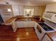 Galley kitchen with white cabinets and granite counters at 313 S Ridgewood Ave, Deland, FL 32720