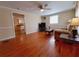 Bright living room with hardwood floors, ceiling fan, and view into kitchen at 313 S Ridgewood Ave, Deland, FL 32720