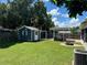 Spacious backyard featuring a storage shed, outdoor grill, covered patio and fire pit at 508 Garden N Dr, Lakeland, FL 33813