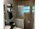 Bathroom featuring a stone surround, and shower with a glass door at 508 Garden N Dr, Lakeland, FL 33813