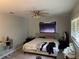 Bedroom featuring a ceiling fan and neutral walls, with a bed dressed in beige linens at 105 Byron Pl, Winter Haven, FL 33884