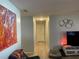 Well-lit hallway with hardwood floors and neutral paint, leading to other rooms at 105 Byron Pl, Winter Haven, FL 33884