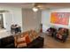 Comfortable living room featuring hardwood floors, modern fan, couch, and stylish decor at 105 Byron Pl, Winter Haven, FL 33884