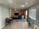 Bright, open living room with hardwood floors, fan, and plenty of space for entertaining at 105 Byron Pl, Winter Haven, FL 33884