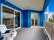 Expansive balcony with blue walls and two sliding glass doors offers plenty of outdoor space at 1 Riverwalk Dr # 302, New Smyrna Beach, FL 32169
