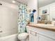 Clean bathroom with tub shower, and beach themed decor at 5300 S Atlantic Ave # 6-505, New Smyrna Beach, FL 32169