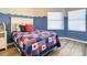Cozy bedroom with nautical-themed bedding and ample natural light at 5300 S Atlantic Ave # 6-505, New Smyrna Beach, FL 32169