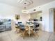 Charming dining room with glass-top table and blue striped chairs at 5300 S Atlantic Ave # 6-505, New Smyrna Beach, FL 32169