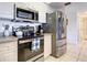 Modern kitchen with stainless steel appliances and white cabinets at 5300 S Atlantic Ave # 6-505, New Smyrna Beach, FL 32169