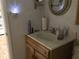 Clean bathroom with single sink vanity and mirror at 4811 Saxon # A201, New Smyrna Beach, FL 32169