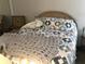 Bedroom with double bed, chair, and patterned bedding at 4811 Saxon # A201, New Smyrna Beach, FL 32169
