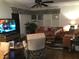 Living room with orange couch, recliner, and large TV at 4811 Saxon # A201, New Smyrna Beach, FL 32169