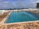 Inviting community pool with surrounding lounge chairs at 4811 Saxon # A201, New Smyrna Beach, FL 32169
