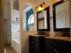 A well-appointed bathroom features dual sinks, dark cabinetry, and a separate bathtub at 1470 Ne Old Mill Dr, Deltona, FL 32725