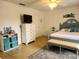 A light-filled bedroom includes a queen bed, dresser, and a decorative rug at 1470 Ne Old Mill Dr, Deltona, FL 32725