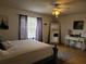 A bright bedroom features a comfortable bed, stylish decor, and ample natural light at 1470 Ne Old Mill Dr, Deltona, FL 32725
