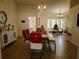 Bright dining room featuring modern furniture, tiled floors, and elegant chandelier lighting at 1470 Ne Old Mill Dr, Deltona, FL 32725